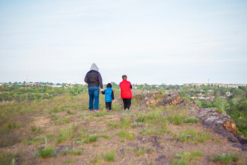 A man and children are standing on a rock and watching what is happening below. panoramic view from above. Russia, Rostov region, skelevataya skala, the 7th wonder of the Don world.