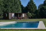 Fototapeta  - Remodeled train carriage for country house with the swimming pool in the forest in summer