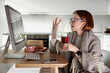 © Eva March - Woman at home in self isolation due to sickness quarantine, using computer for online communication while social distancing. Celebrating and having fun, connection with friends and family on remote.