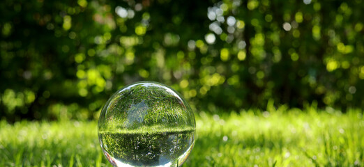 landscape with glass lens ball in the garden