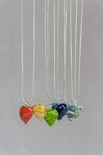 Closeup Shot Of The Colorful Handmade Glass Heart Shaped Necklaces Isolated On A White Background