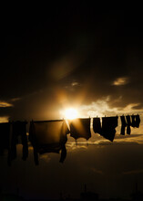 Vertical Shot Of The Sun Shining On Hanging Laundry Silhouettes In Yerevan, Armenia