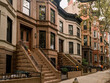 Scenic view of a classic Brooklyn brownstone block with a long facade and ornate stoop balustrade in Park Slope neighborhood, New York, USA