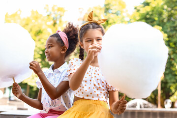 Wall Mural - Cute little girls with cotton candy outdoors