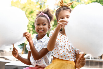 Wall Mural - Cute little girls with cotton candy outdoors