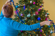 Woman decorating a Christmas tree
