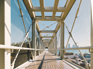 Sticker - Closeup of a white metal bridge with a blue sky background