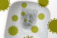 Corona Virus Cells Take Off In A Flushed Toilet Bowl. Covid Infection By Airborne Droplets. The Concept Of Coronavirus In Human Waste Cells.