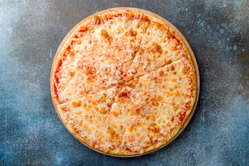 Wall Mural - Italian pizza Margherita with cheese and tomato sauce on dark blue stone table top view (Margarita)