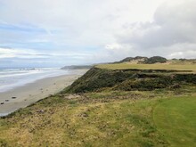 A Beautiful View Of A Parkland Area With A Par 4 Golf Hole In Bandon, Oregon, With The Ocean In The Background And Yellow Heather In Bloom
