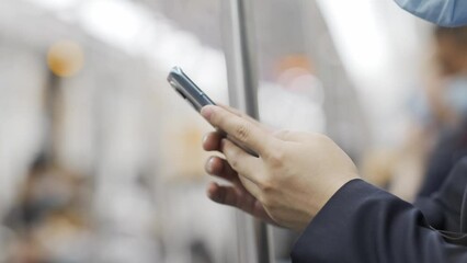 young man using mobile phone in subway