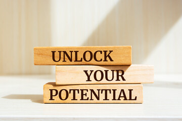 Wall Mural - Wooden blocks with words 'Unlock Your Potential'.