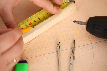 Sticker - Foreman draw line on wooden piece, use measure tape and pencil