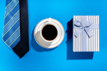 Wall Mural - Father day greeting card background. Fathers day concept with gift box, tools and ties, coffee cup, gift tag Love you dad, on bright blue background top view copy space