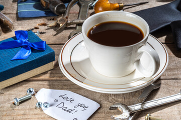 Wall Mural - Father day greeting card background. Fathers day concept with gift box, tools and ties, coffee cup, gift tag Love you dad, on rustic wooden background top view copy space