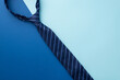 Father's Day concept. Top view photo of blue necktie on bicolor blue background with copyspace