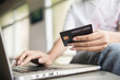 © 2April - Woman entering credit card information to transact on website via laptop.