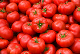 Fototapeta Kuchnia - .Tomatoes lying on a pile on top of each other, tomato texture. Selective focus.