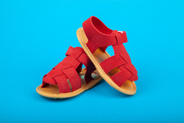 Pair of baby sandals shoes on blue background