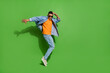 Full body image of good mood young man have fun relaxing on weekend in nightclub isolated on green color background