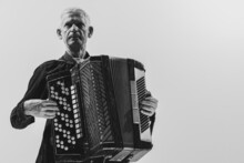 Monochrome Portrait Of Seniot Man, Retro Musician Playing The Accordion Isolated On White Background. Concept Of Art, Music, Style, Older Generation, Vintage
