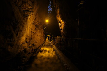 Inside the black cave, cave inside at single illumination incandescent lamp 