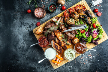 Wall Mural - delicious grilled meat with vegetable. Mixed grilled bbq meat with vegetables on wooden platter. Restaurant menu, dieting, cookbook recipe top view