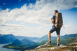 Traveller with backpack and mountain panorama
