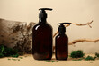 SPA natural organic cosmetics packaging design. Set of dark brown amber glass shampoo dispenser bottles. Tree branch, birch bark and moss on background.
