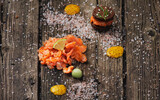 Fototapeta Sawanna - Fresh salmon cuts served on the wooden table with salt and lemon in the fine dining restaurant 