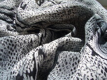 Gray Fabric With Animalistic Snake Skin Print. Textile Background. Knit Fabric With Light Gray Pattern.