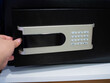Women 'hand open or close the safe deposit box in the hotel or home for protection and security concept