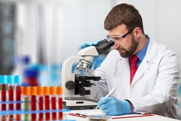 Wall Mural - Woman scientist working in lab. Research concept. Microscope at blood and chemical test sample