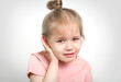 Child with earache, toddler girl portrait ear pain concept.