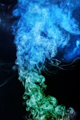 Wall Mural - Green-blue smoke in neon light on dark background.