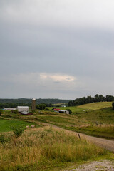 Wall Mural - Amish Farm in the country under a cloudy sky along a dirt road