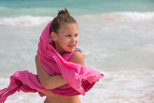 Pretty Little Girl With Pink Shawl Stands On An Ocean Coast. Outdoor Portrait