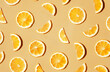 Pattern of many sliced lemons and oranges on a trendy bright yellow background. Flat lay, top view. Summer freshness, detox, antioxidants, healthy lifestyle concept