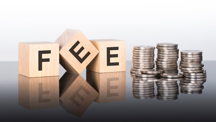 Poster - fee - text is made up of letters on wooden cubes lying on a mirror surface