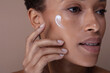 © Connect Images - Close-up of woman applying moisturizer on face