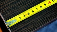 Close-up Of A Yellow Metal Measuring Tape Placed Horizontally
