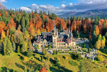 Peles Castle, Sinaia, Prahova County, Romania: Drone View Of Famous Neo-Renaissance Castle In Autumn Colours, At The Base Of The Carpathian Mountains, Europe