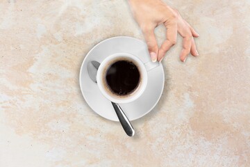 Poster - Female hand with white cup of coffee on pastel background