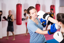Young Females In Sportswear Training On Each Other Different Boxing Blows