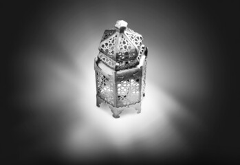 Canvas Print - Ornamental Arabic lantern with burning candle on white-black background. Muslim holy month Ramadan Kareem.