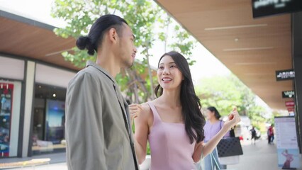 Wall Mural - Asian young man and woman shopping goods outdoors in department store.	