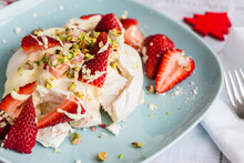 Individual Dessert For Christmas, A Smashed Meringue Topped With Cream, Strawberries, Pistachio