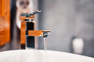 Wall Mural - Water tap , faucet. Flow water in bathroom with sink. Modern clean hause. Hygiene concept. Panorama