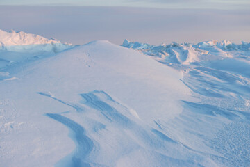 Wall Mural - winter arctic landscape. view of snow and ice at sunset. ice hummocks on the frozen sea in the arcti