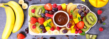 Platter With Various Fruits And Chocolate Sauce